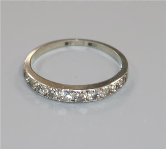 An 18ct white gold and ten stone diamond set half eternity ring, size M.